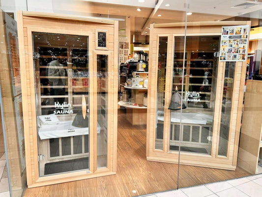 Infrared sauna showroom at Kylin Sauna Perth, displaying premium wood cabin units with glass doors and in-store setup.